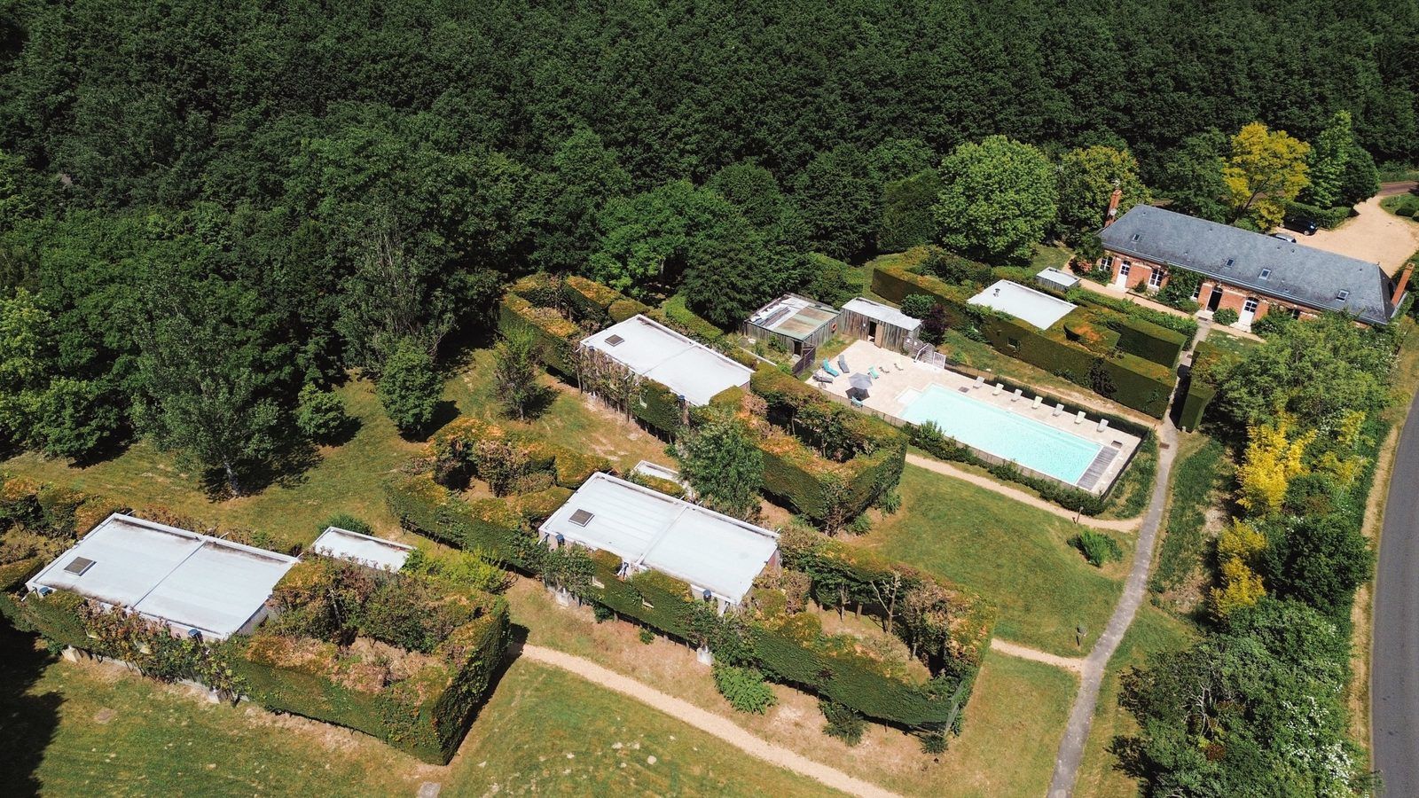 Aerial view of the chalets surrounded by their green walls